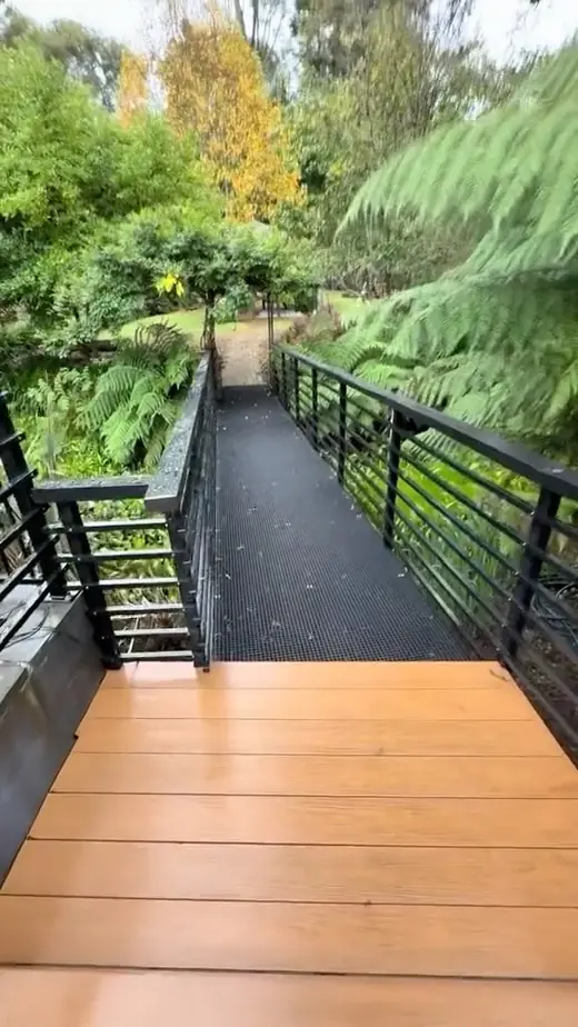 Black steel balustrade beside a timber deck walkway
